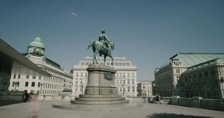 People move around a statue