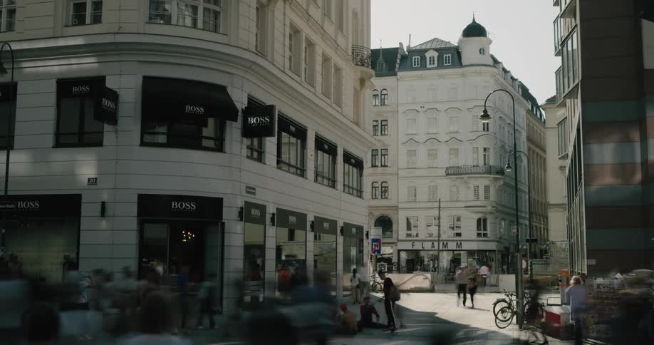 People walk through an intersection in an urban area