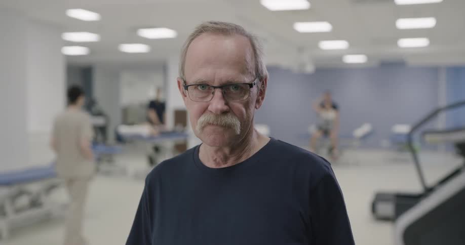 A man standing in a fitness clinic looking into the camera