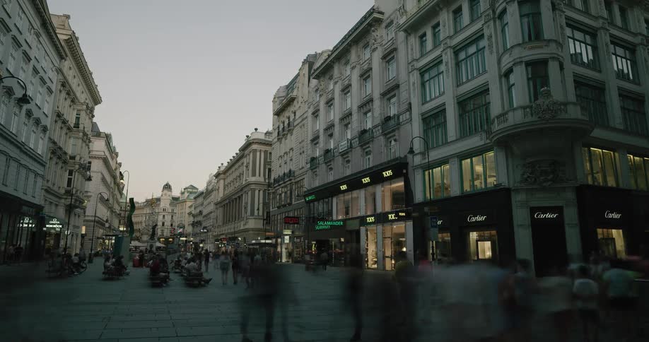 Several walk through a plaza in an urban area