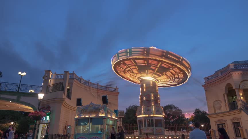 A swing ride at a carnival at dusk