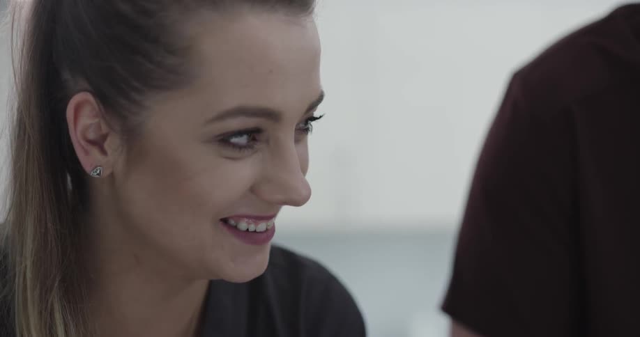 A woman in an office smiling and nodding her head