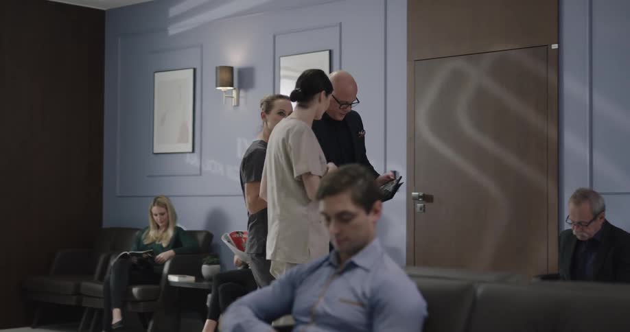 People walk through a waiting room together