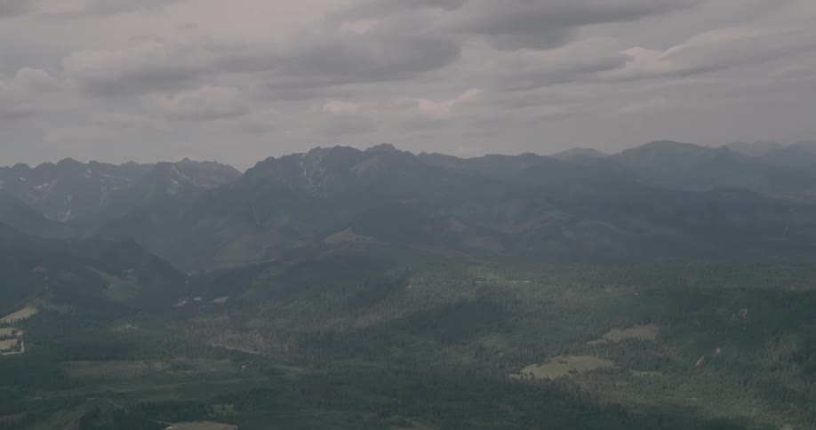 Storm clouds over hilly terrain covered in trees