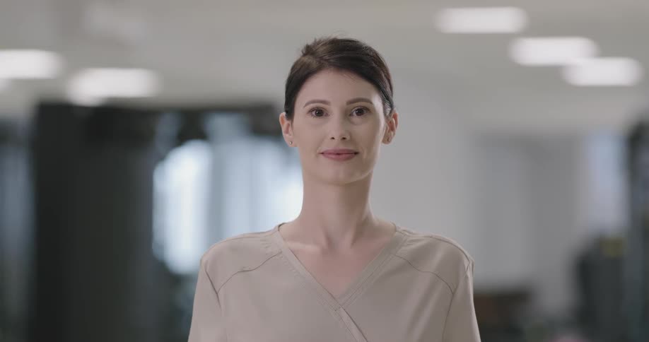 Woman looks at the camera and smiles in the hospital