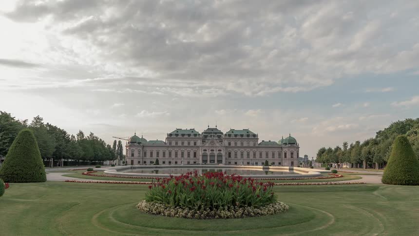 Time lapse of a large building and people walking around the grounds