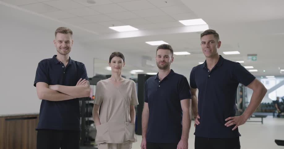 Physical therapists stand in gym