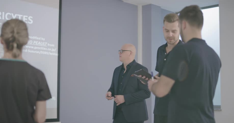 A group of people discussing about something on the screen