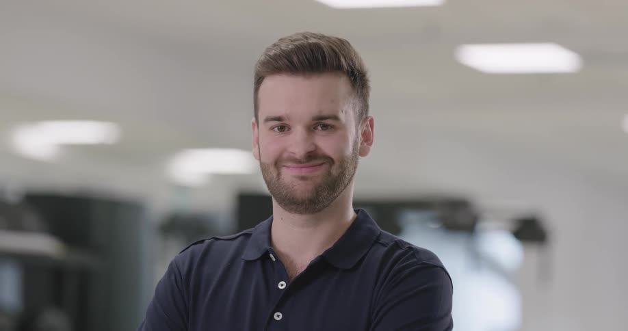 A man is facing forward smiling
