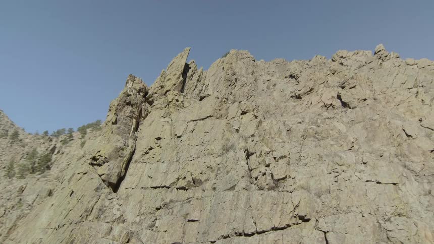 Rocks cover the side of a cliff in the wilderness