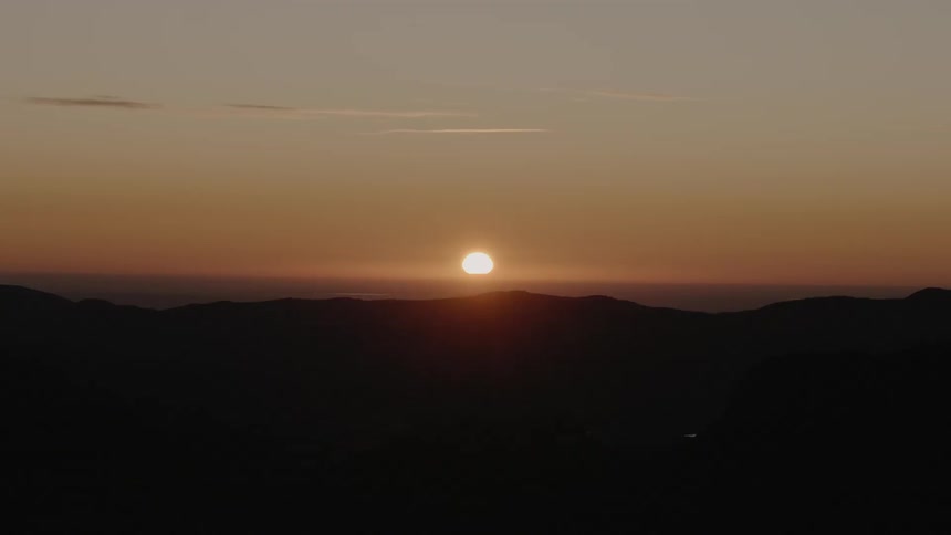 A scenery of a sunset on the mountain