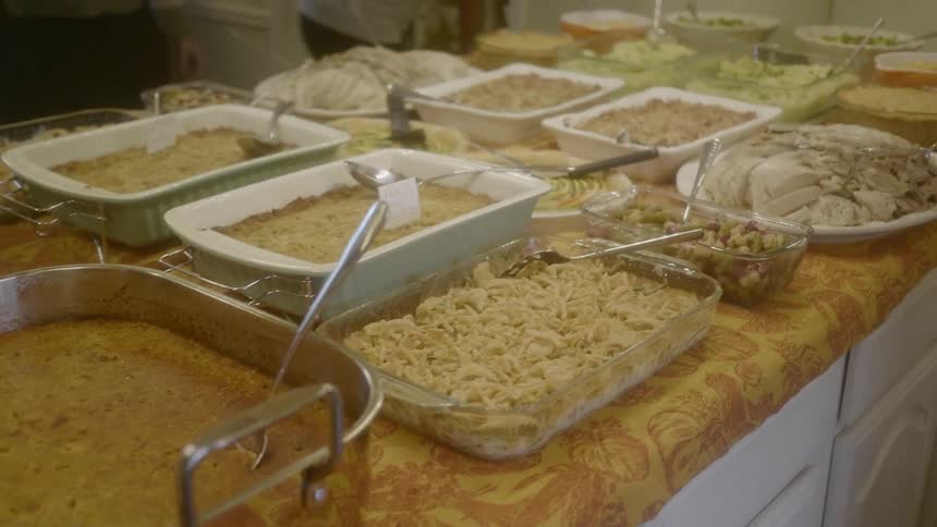 An array of casseroles and platters of food on a large kitchen island
