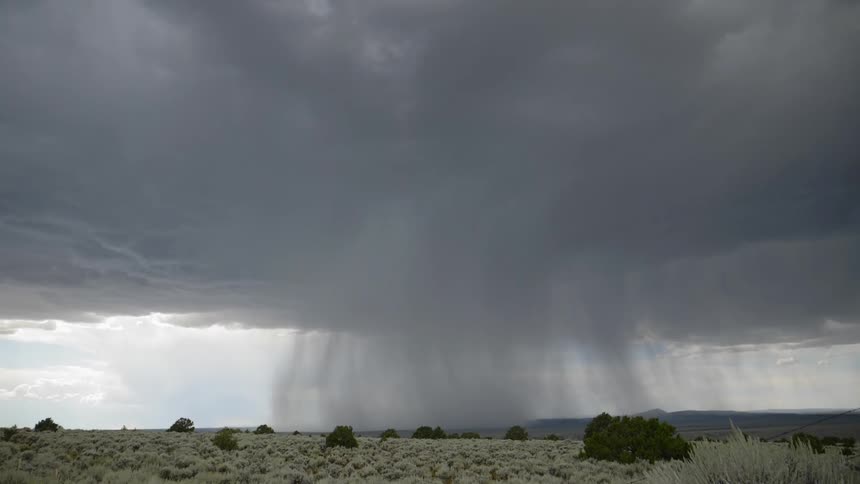 Lightning strikes ground on plains with mountain on horizon