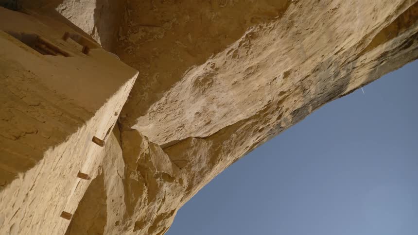 Worms eye view of a cliff and cement structure