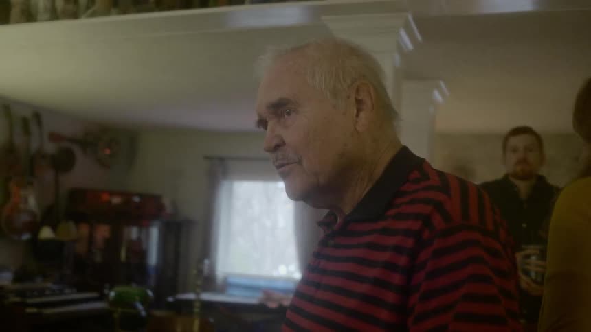 An old man arguing with someone at the house