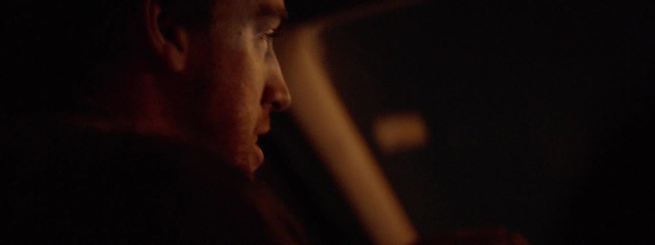 A driver talks to his front seat passenger while driving at night