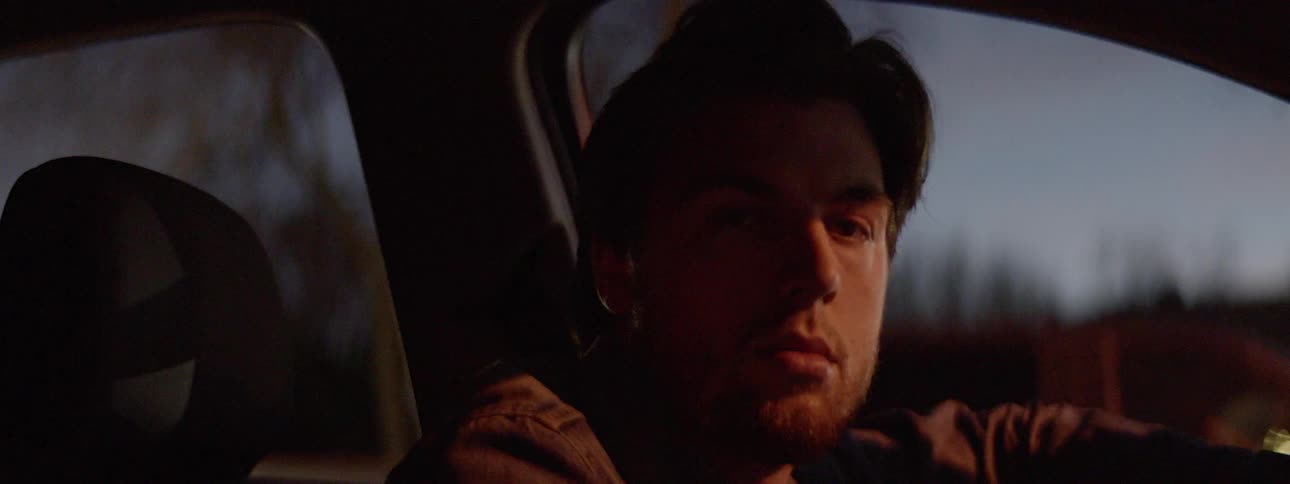Man stare blankly from the car