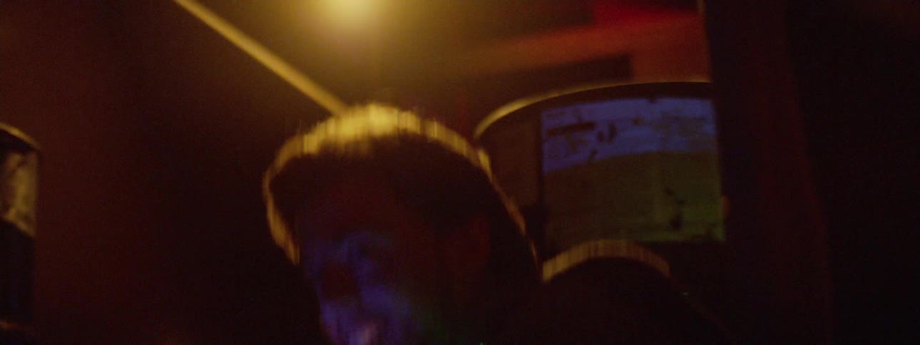 A man laughs as he plays a game of laser tag in a gaming arena