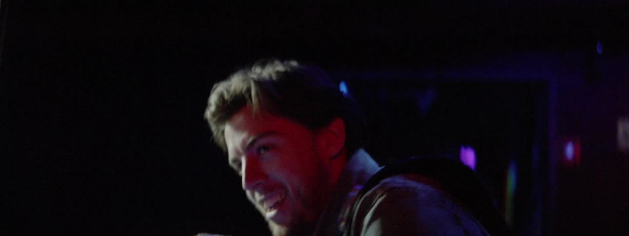 A man points a laser tag gun at another person