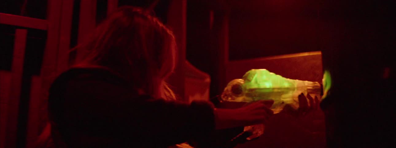 A woman is holding a plastic gun that flashes green