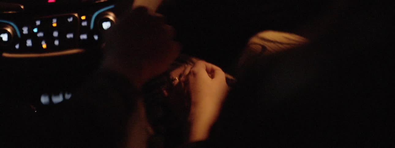 People hold hands in a car