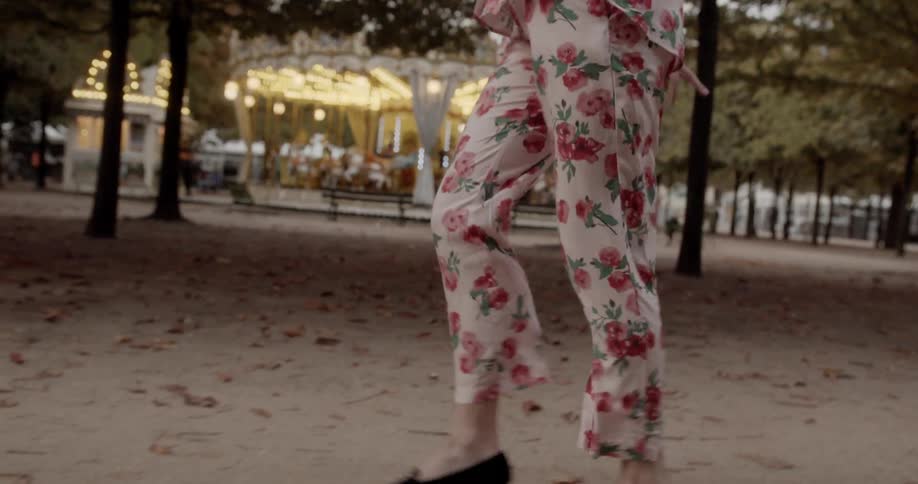 A woman skips along in her pyjamas