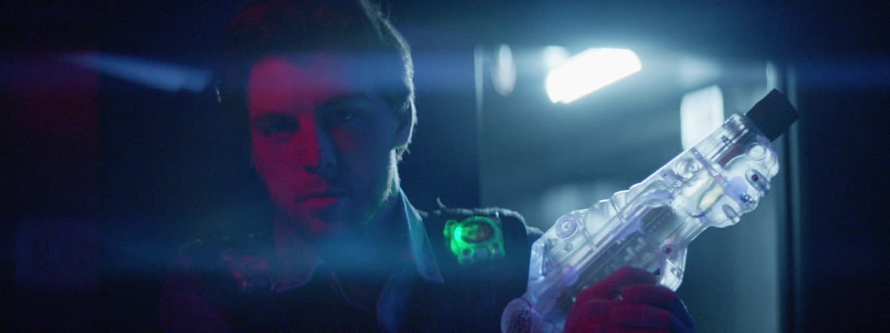 A man posing with a laser gun under the flare