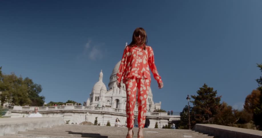 Woman with pajamas dancing happily on the stair