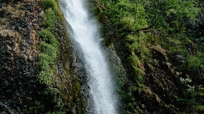 A waterfall crashes down the side of a hill
