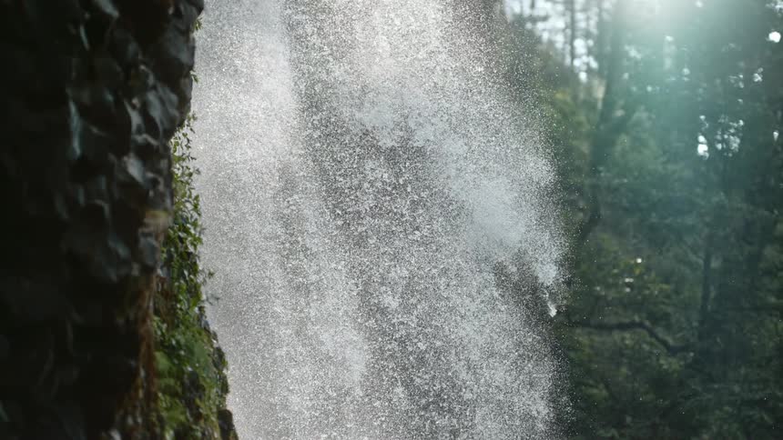 Water falls down the side of a hill