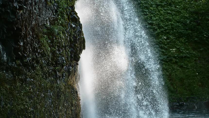 The waterfall pours into the spring in the wilderness