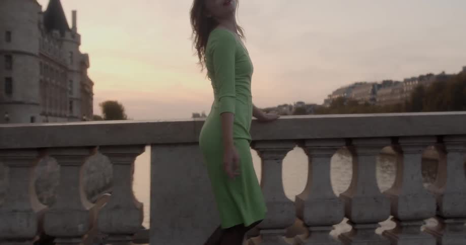 A woman struts across a bridge