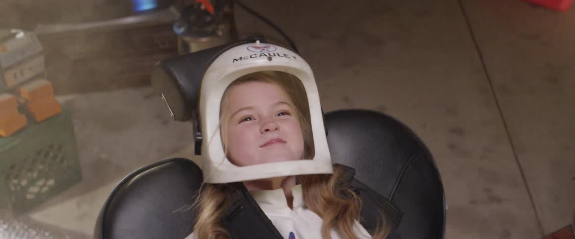 A girl play as an astronaut prepare to take off