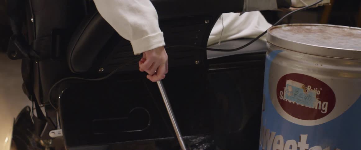 A person moves up the joystick on a powered chair