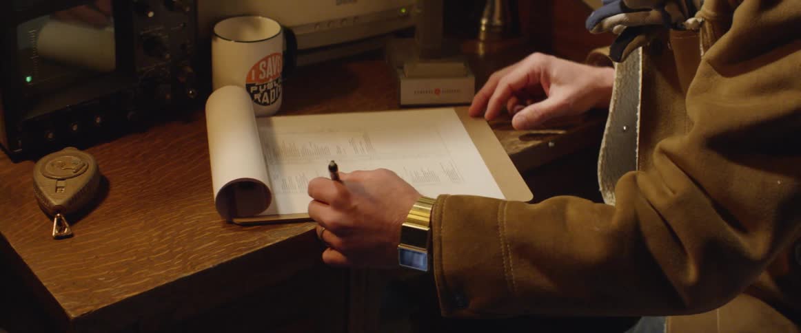 A person is writing on a piece of paper