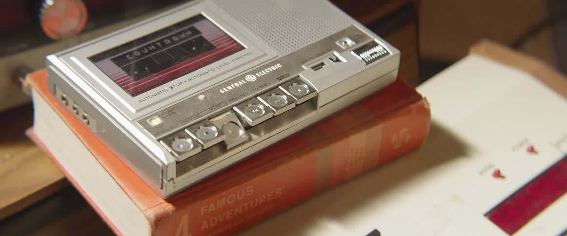 A person presses play on the tape recorder