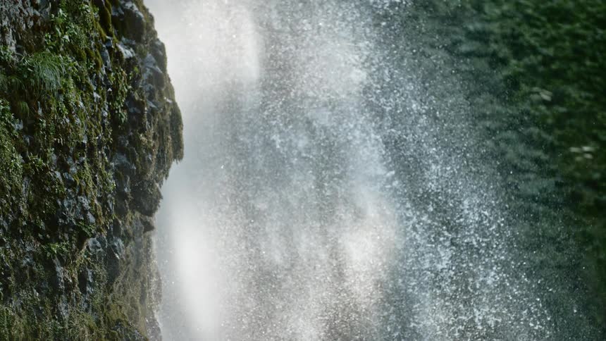 A water fall crashes down the side of a hill