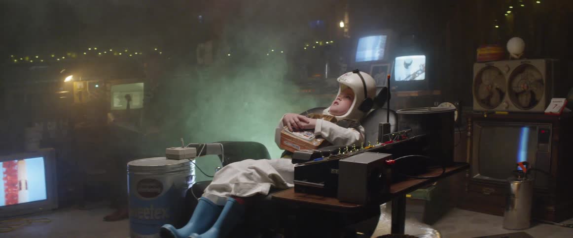 A boy playing as an astronaut at the garage