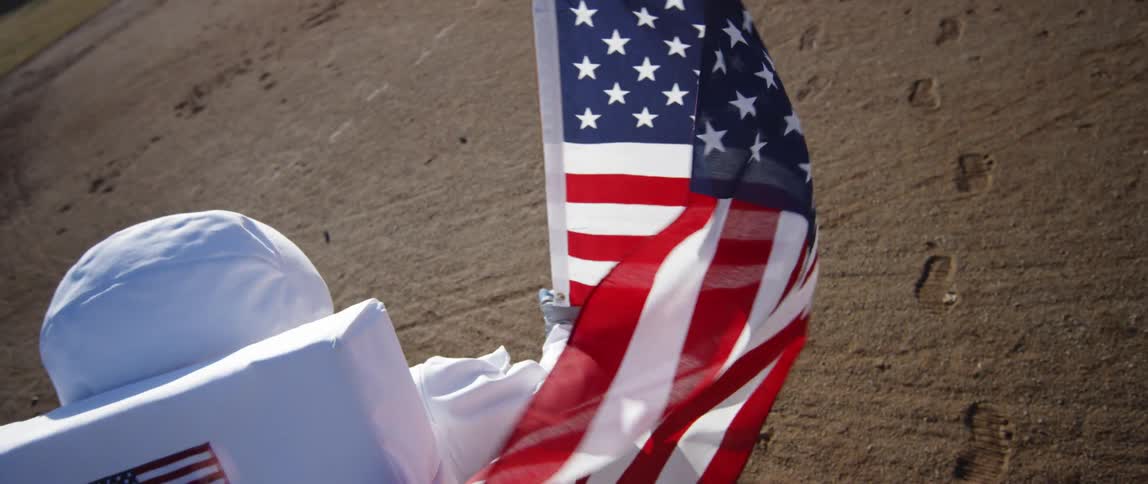 Astronaut placing an american flag on the moon