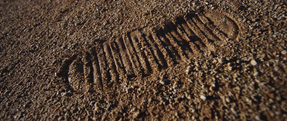 A close up of a foot print in the soil