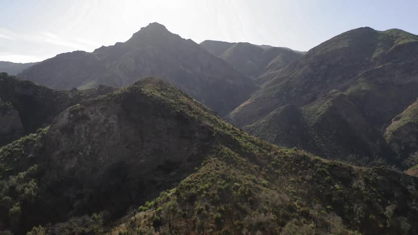 Passing over green mountain peaks and ridges