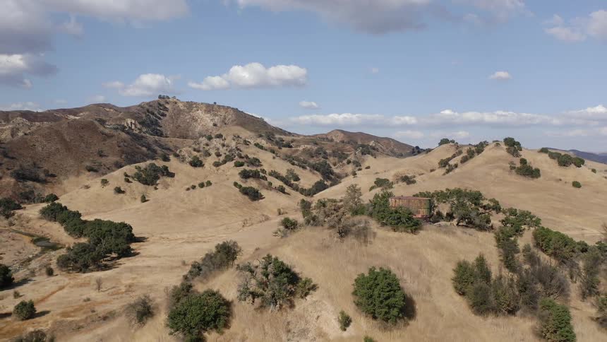 An aerial view of a hill and grassland