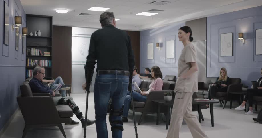 A patient walks into the busy hospital waiting room