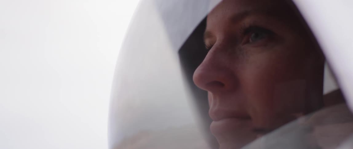 A face of a woman astronaut on the suit