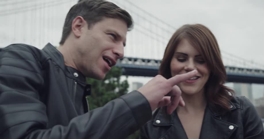 Couple takes a picture under brooklyn bridge