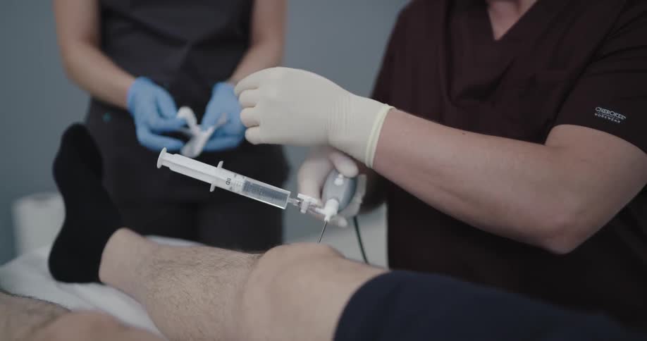 A man is in a hospital with doctors working on him