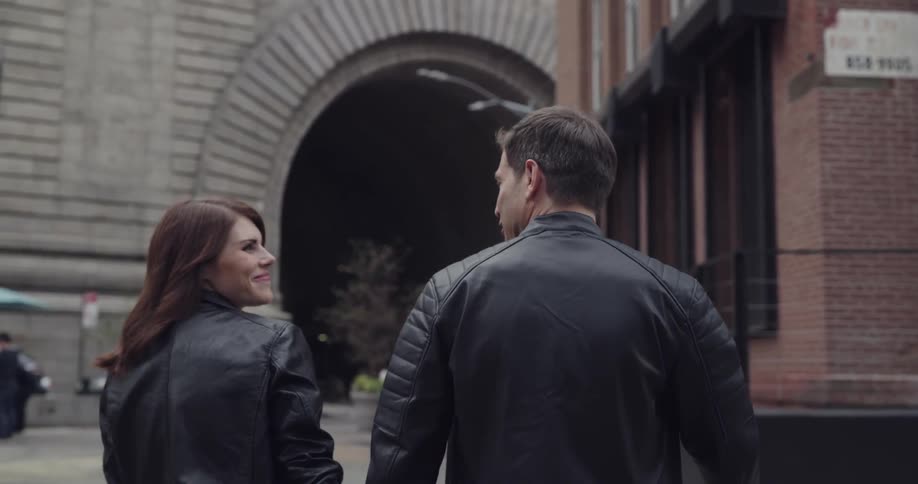 A man and a woman walking down a street