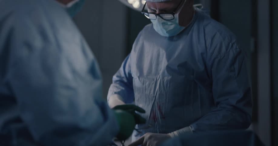 Doctor operates on patients hand