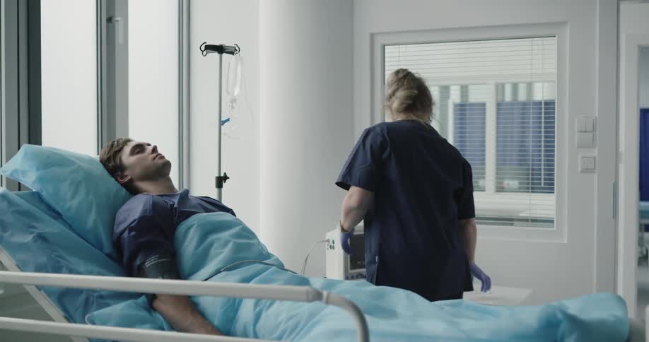 A nurse hooks an intravenous up to a man