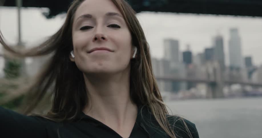 A woman smiles as she looks to the camera